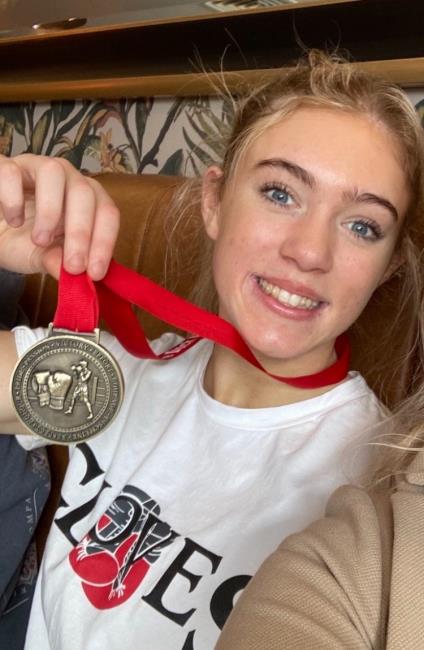 Ffion Evans proudly displays a medal